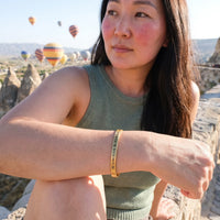 Thumbnail for Mantra bracelet — worn on a getaway, gold | SKU: bgby-g