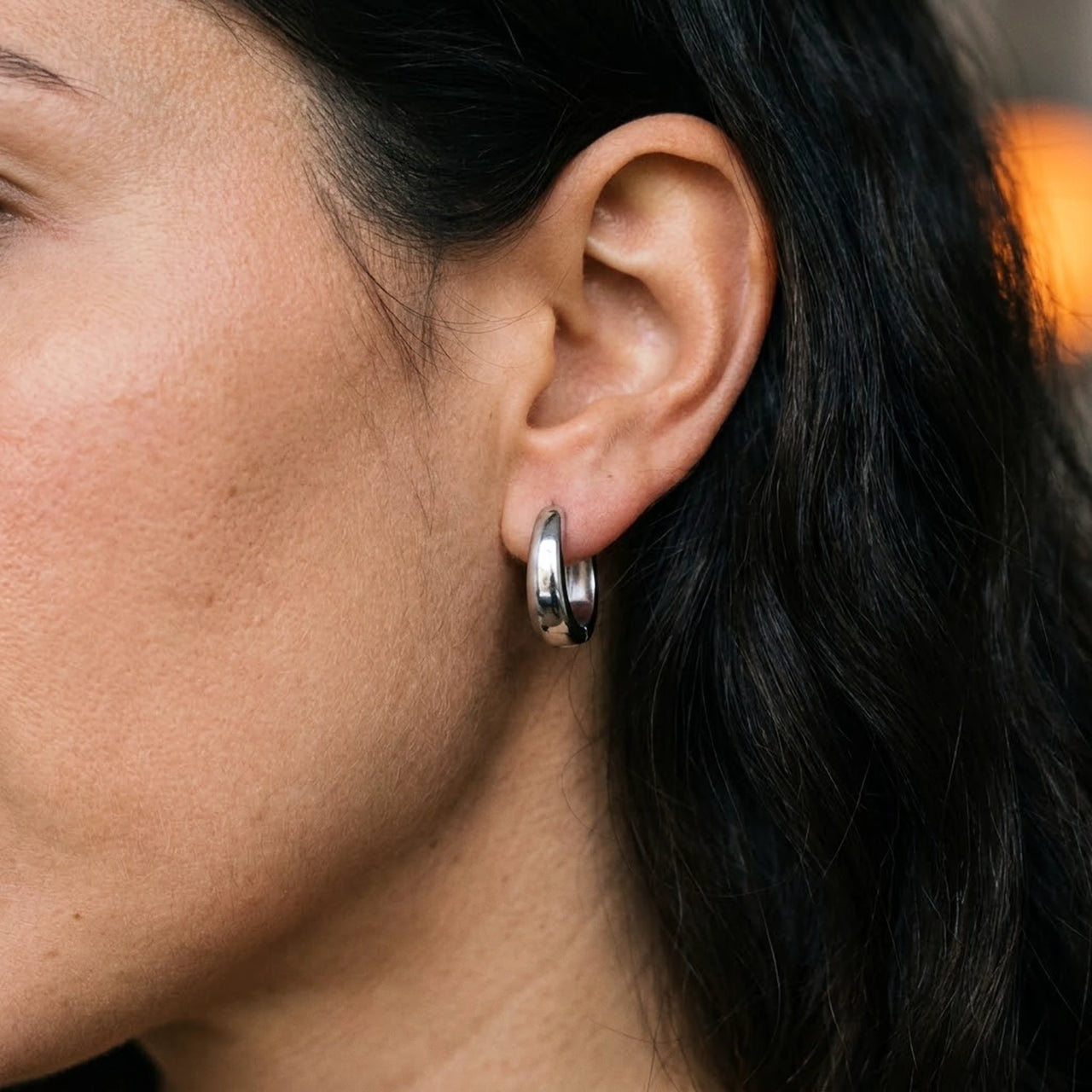 Chunky Dome Hoops in Silver, close-up on the earlobe | SKU: 41005-silver
