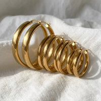 Thumbnail for Huggie Hoop Earrings Set of 4 Pairs in Gold, macro detail of the metal and the finish | SKU: huggie-set-gold