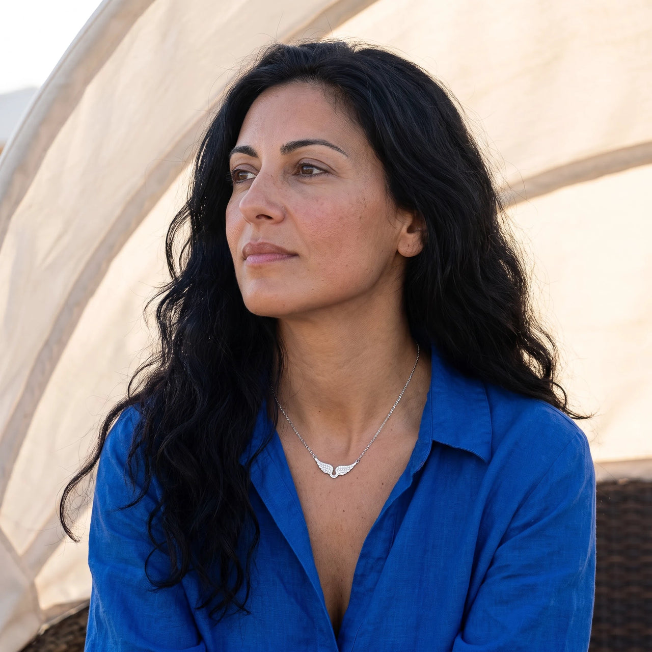 Profile view of a woman wearing the silver necklace | SKU: 42002-silver