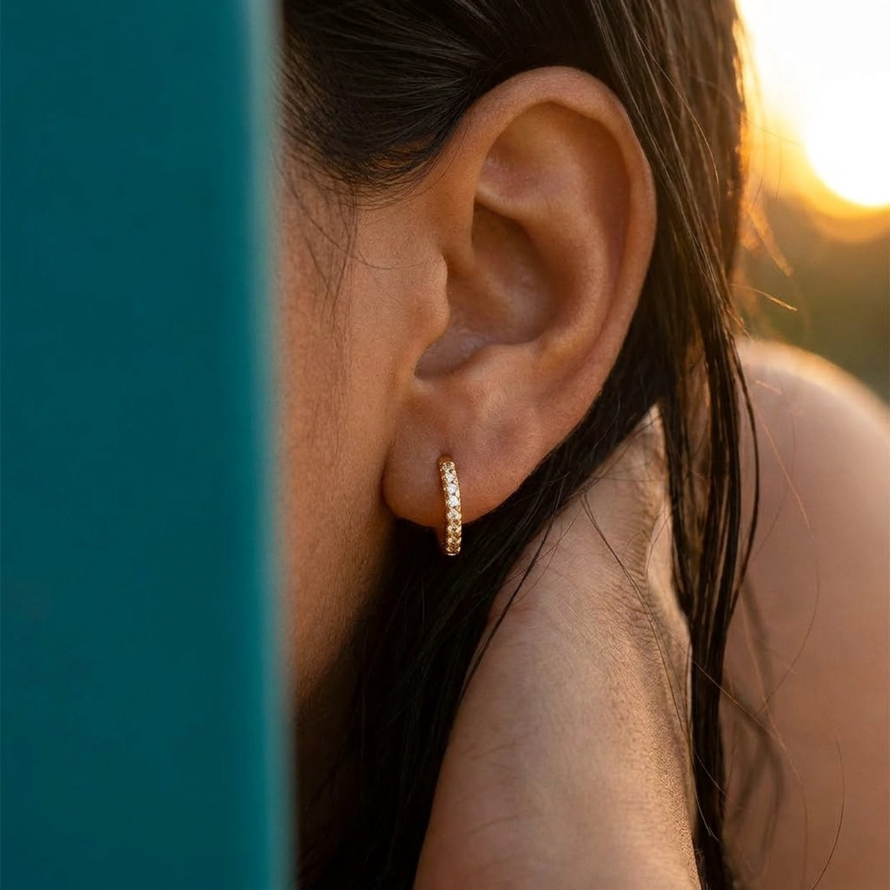 Pave Huggie Hoop Earrings in Gold, close-up on the earlobe | SKU: 41011-gold