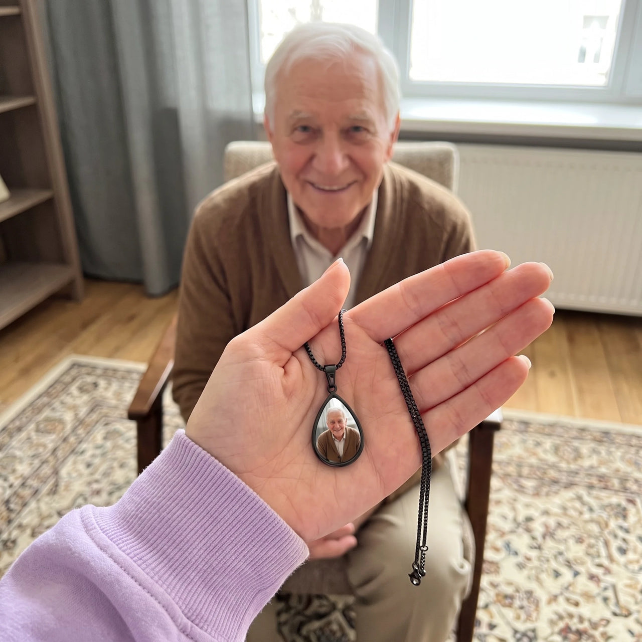 Customer photo: the black drop photo necklace with her grandfather's photo, her grandfather smiling behind | SKU: TPH-DRPN-BLACK