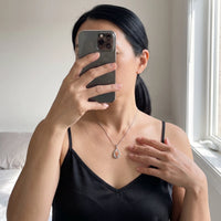 Thumbnail for Mirror selfie of a woman in a black camisole wearing the silver secret drop photo necklace | SKU: TPH-DRPN-SILVER