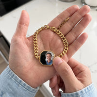 Thumbnail for Thumb warming the gold octagon bracelet plate: the hidden photo appears under the thumb while the rest stays black | SKU: TPH-OCTB-GOLD-18