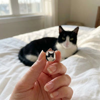 Thumbnail for Customer photo: the rose gold octagon necklace with her cat's photo, her cat in the background | SKU: TPH-OCTN-ROSEGOLD