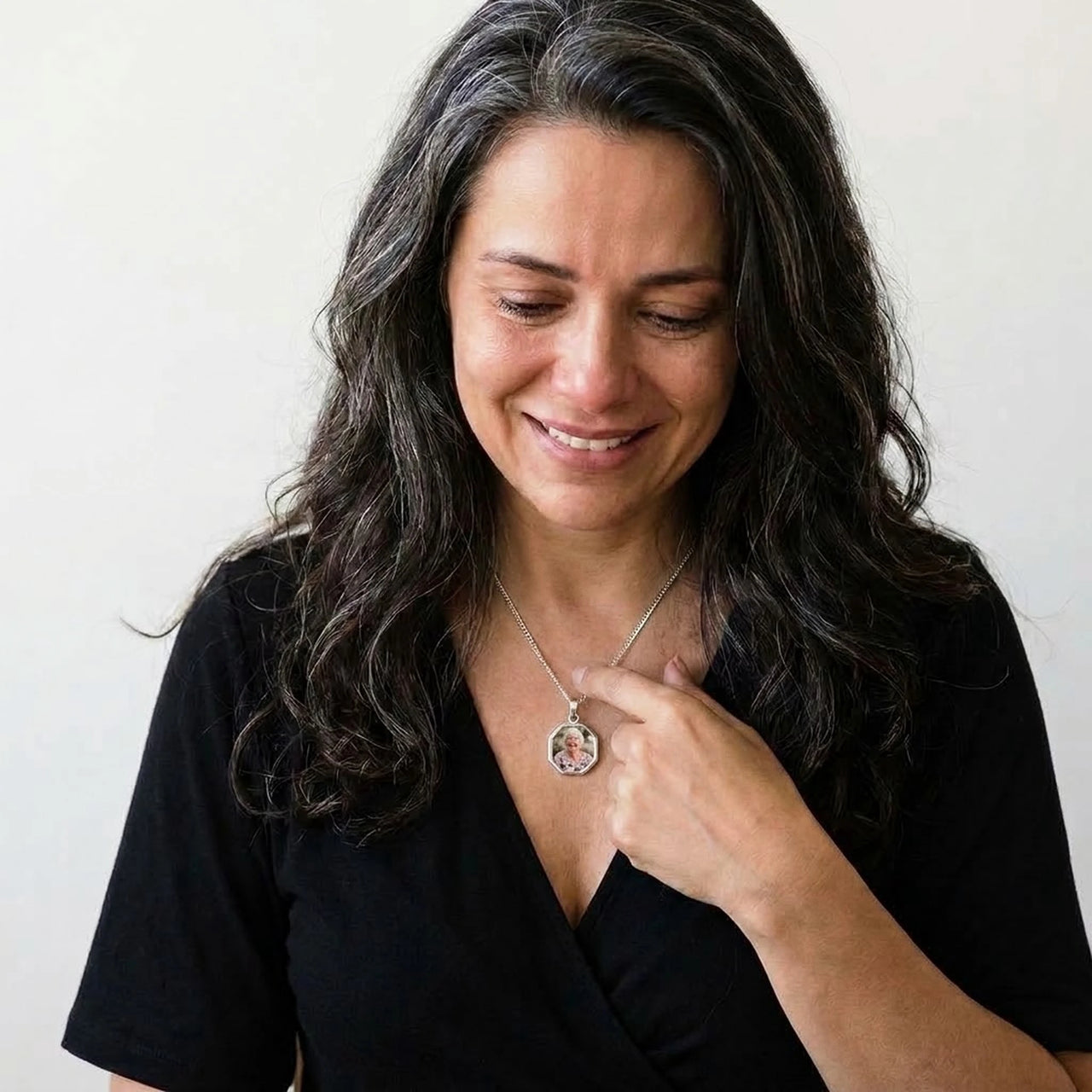 Woman moved as she looks at her late grandmother's photo in the silver octagon necklace | SKU: TPH-OCTN-SILVER