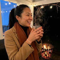Thumbnail for Femme portant le Crystal Bar Bracelet sur une terrasse d'hiver pres d'un brasero